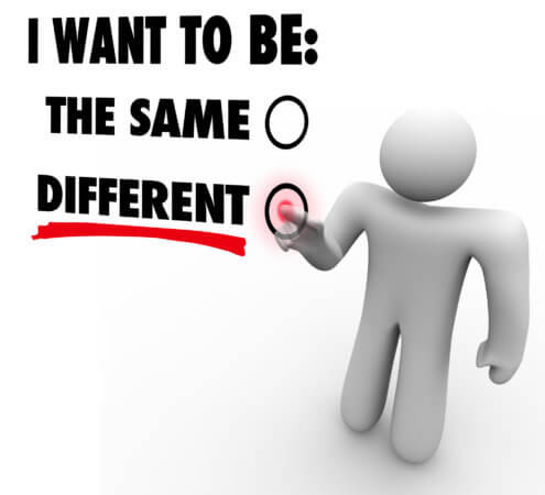 The phrase is "I want to be: the same" with a checkbox, and the word "different" with a checkbox. A gummy human figure is pointing to the word "Different".